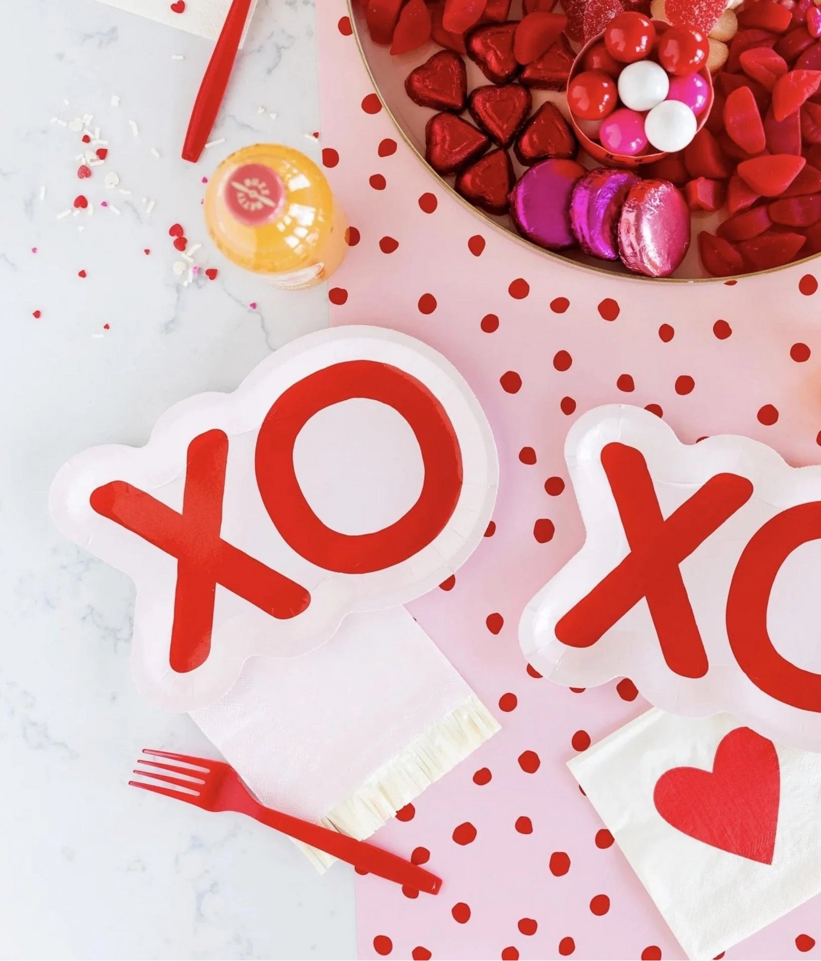 Valentine's Day-themed plates with 'XO' design on a polka dot background